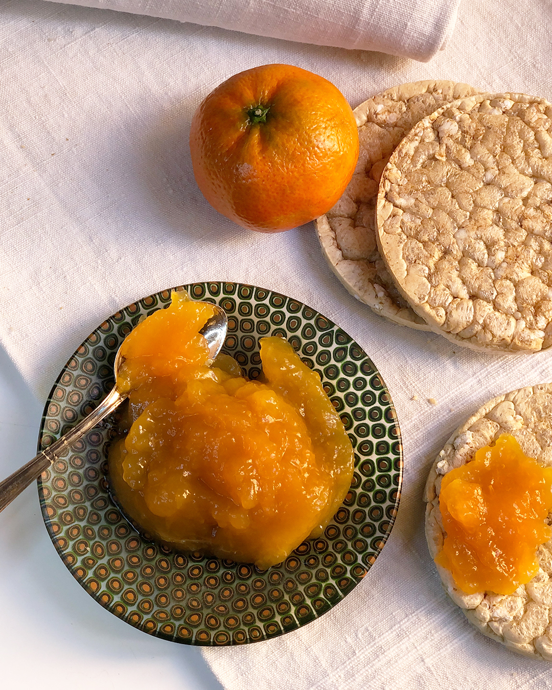 late mandarin marmalade with fruit, bread and a dish