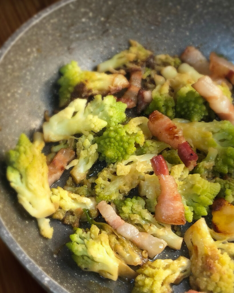 broccolo and pancetta cooked into a pan