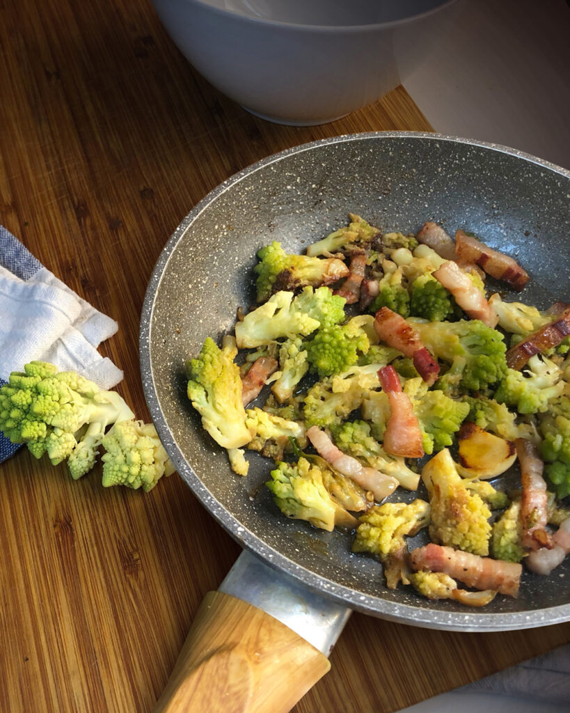 a pan with broccoli and pancetta