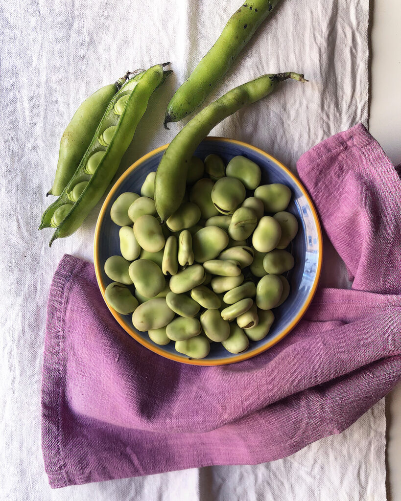 broad beans viewed from the top with a pink napkin