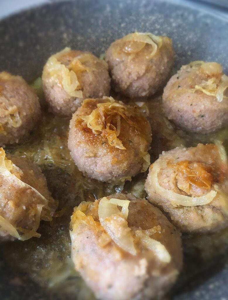 polpette meatballs cooking on a skillet