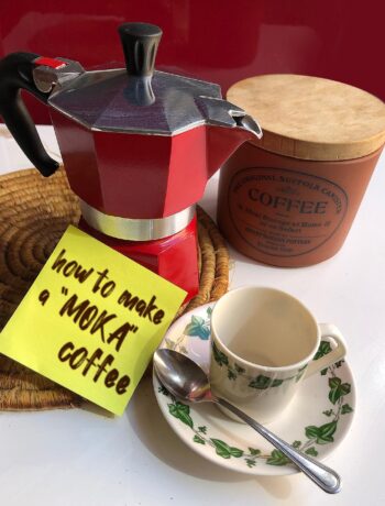 "moka" coffee maker, coffee and a coffee cup