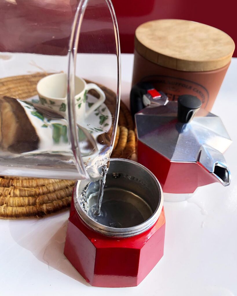 putting water into a "moka" coffee maker