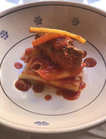 pasta and meat rolls with tomato sauce in a pan