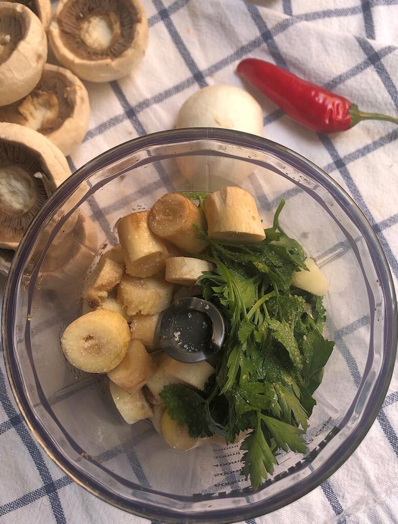 mushrooms, parsley, garlic and oil in a blende ready to be mixed