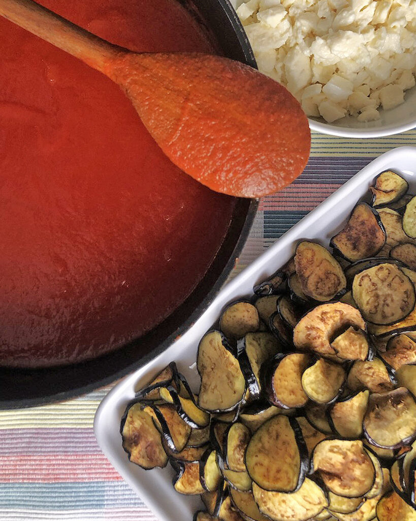 fried eggplant slices, tomato sauce and mozzarella diced