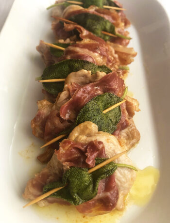 saltimbocca alla romana served on a beautiful white dish