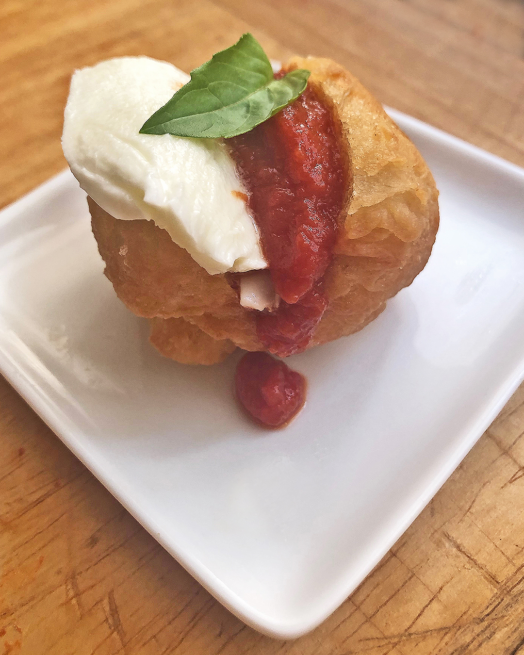 fried pizza with tomato sauce and mozzarella