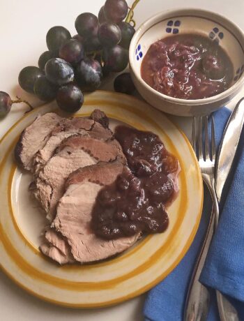 grape roasted pork on a dish with it's lovely grape sauce