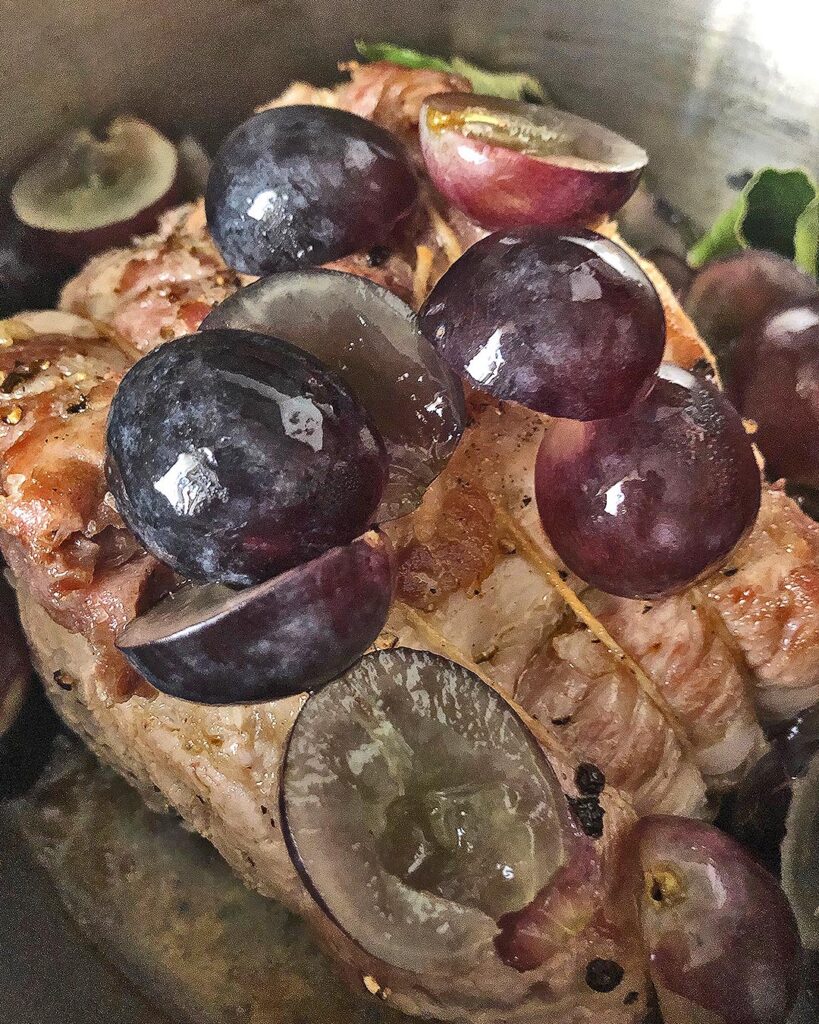 close up of pork and grapes into the pan