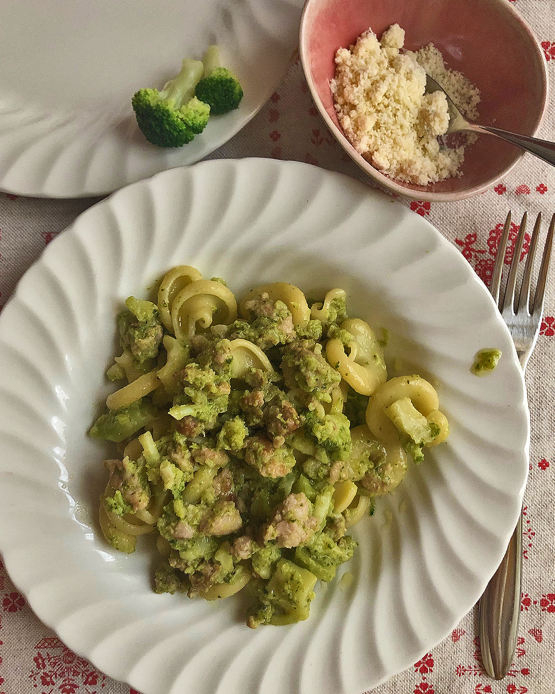 pasta with broccoli and sausage served on a white dish