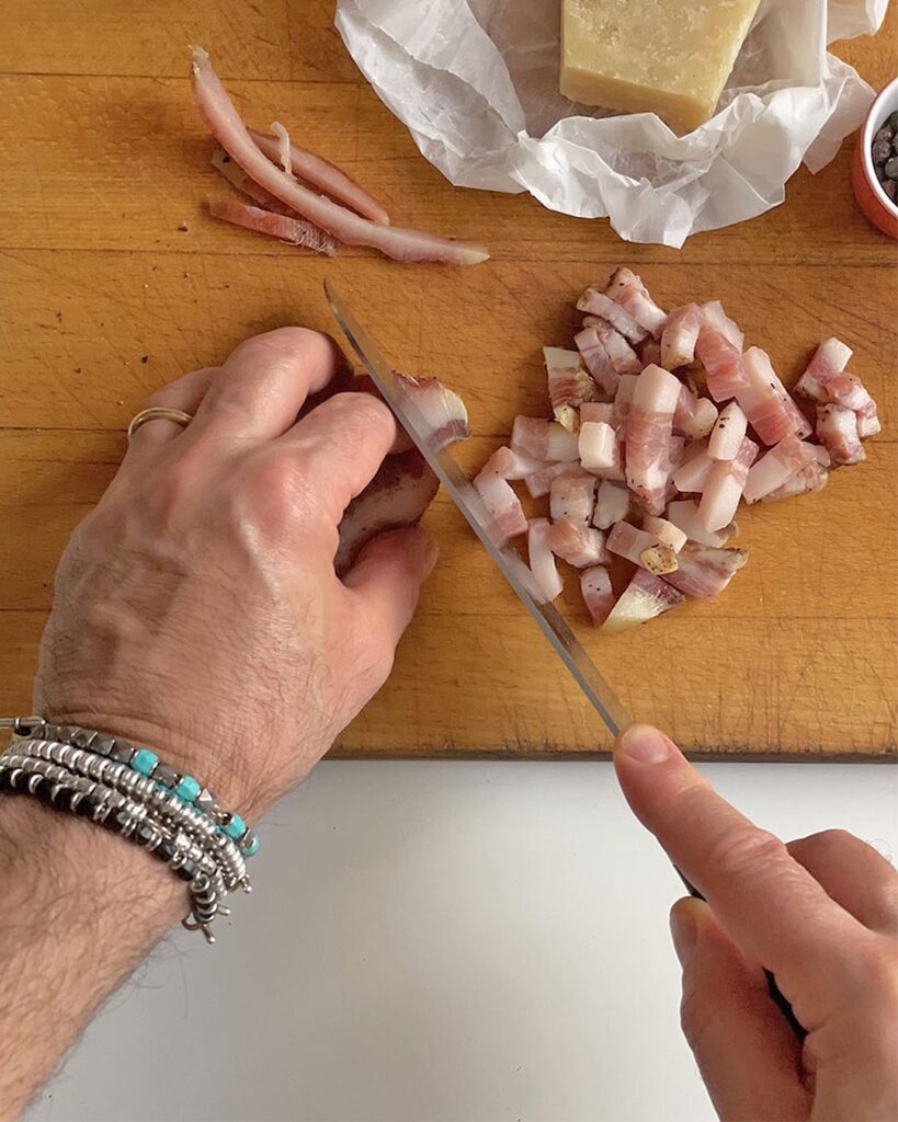 Chopping Guanciale in little cubes