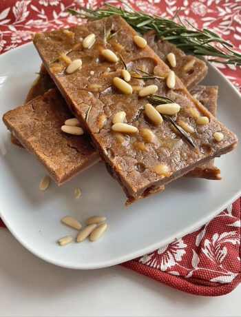 closeup of slices of castagnaccio in a white dish