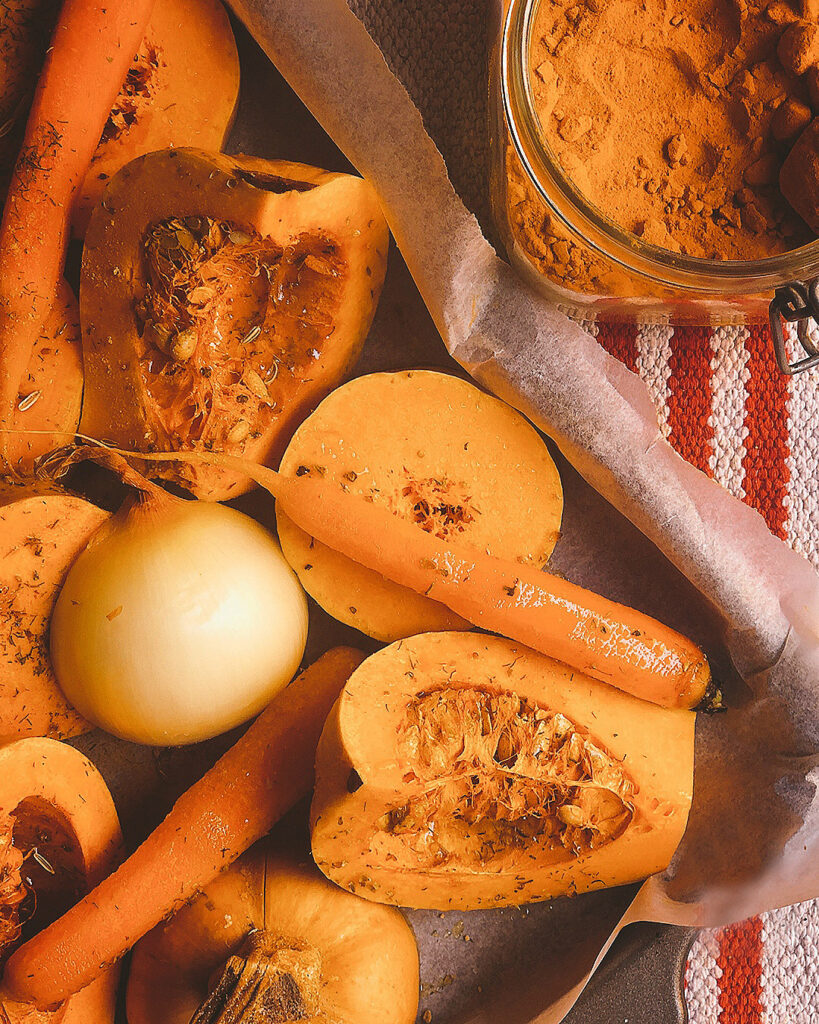 close up of autumn roasted veggies: pumpkin, carrotts, fennel and onions