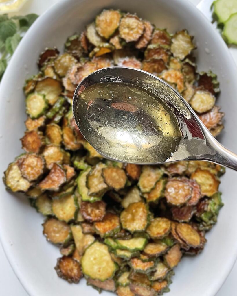 adding vinegar to fried zucchini