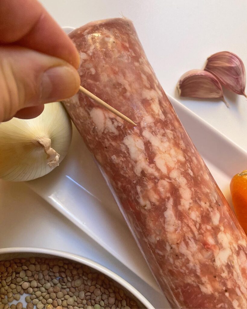 Piercing cotechino with a toothpick