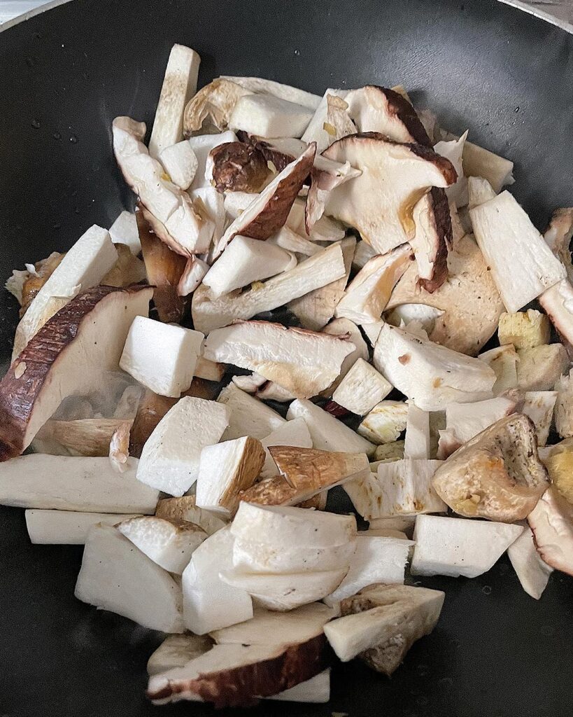 chopped porcini mushrooms cooked in a skillet with oil and garlic