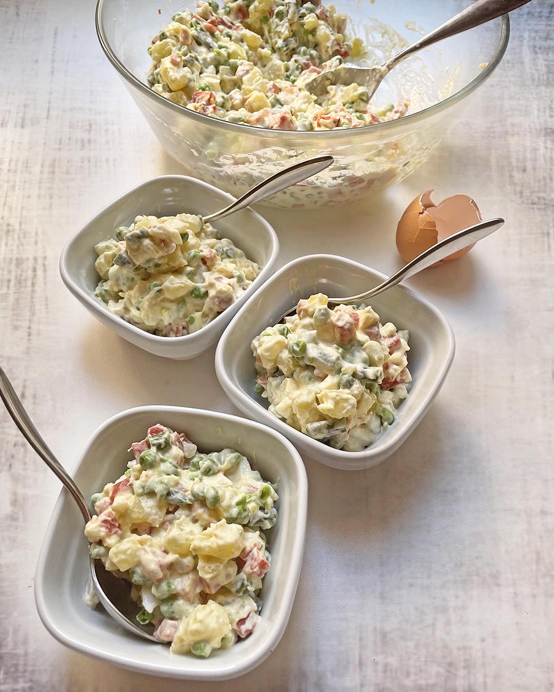 insalata russa served in 3 different withe cups