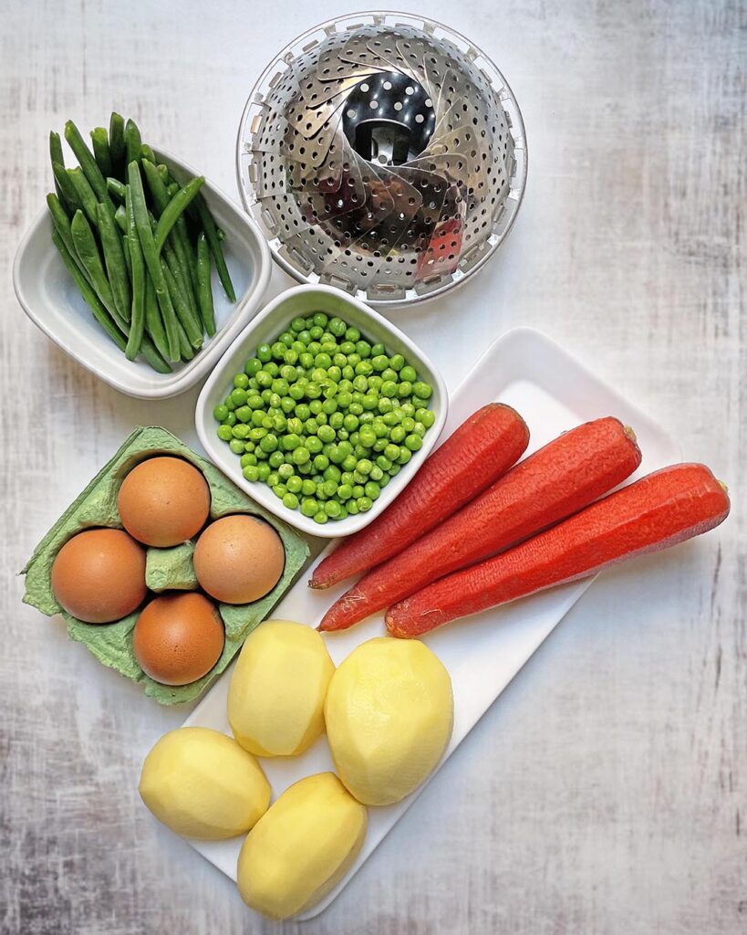 Ingredients for insalata russa: potatoes, carrotts, peas, eggs