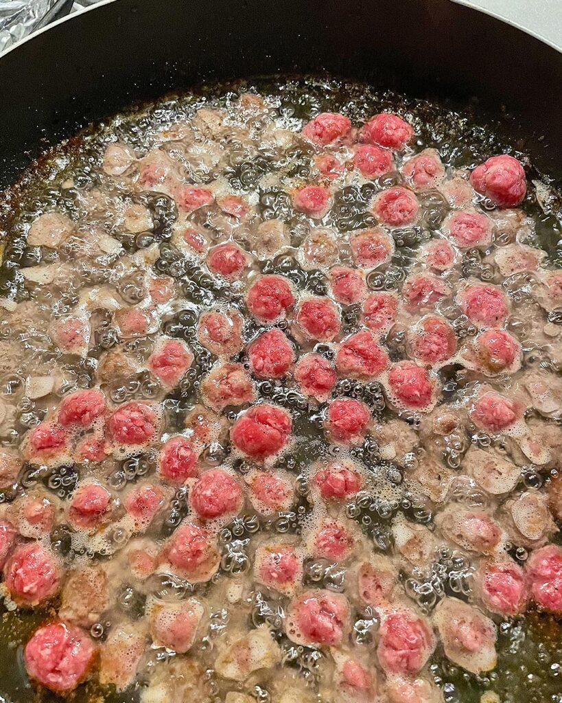 meatballs frying in olive oil