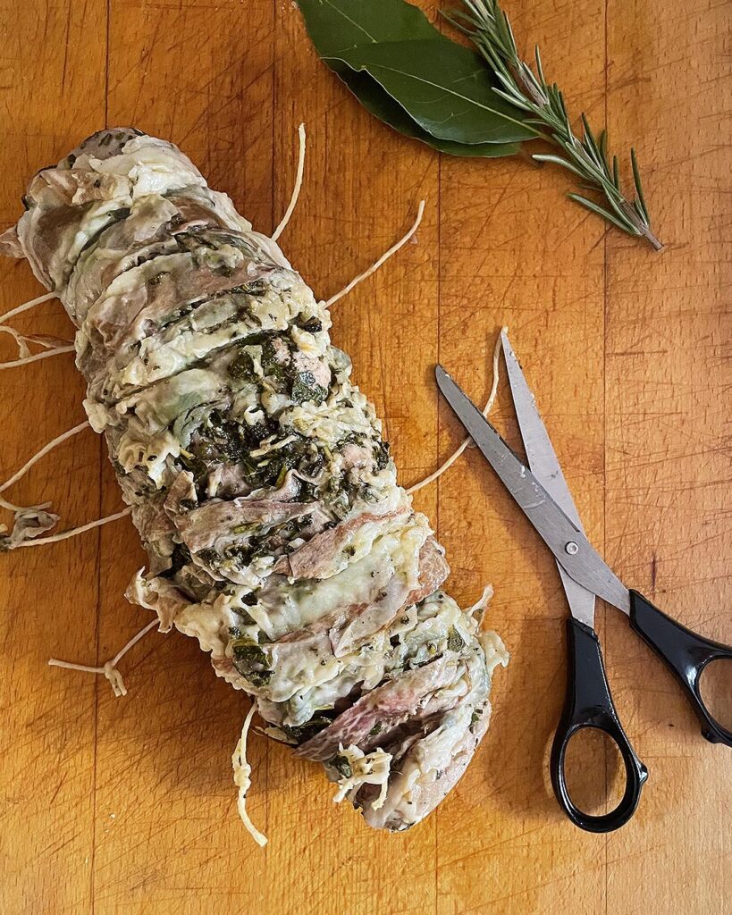 cooked fillet with herbs ready to be sliced