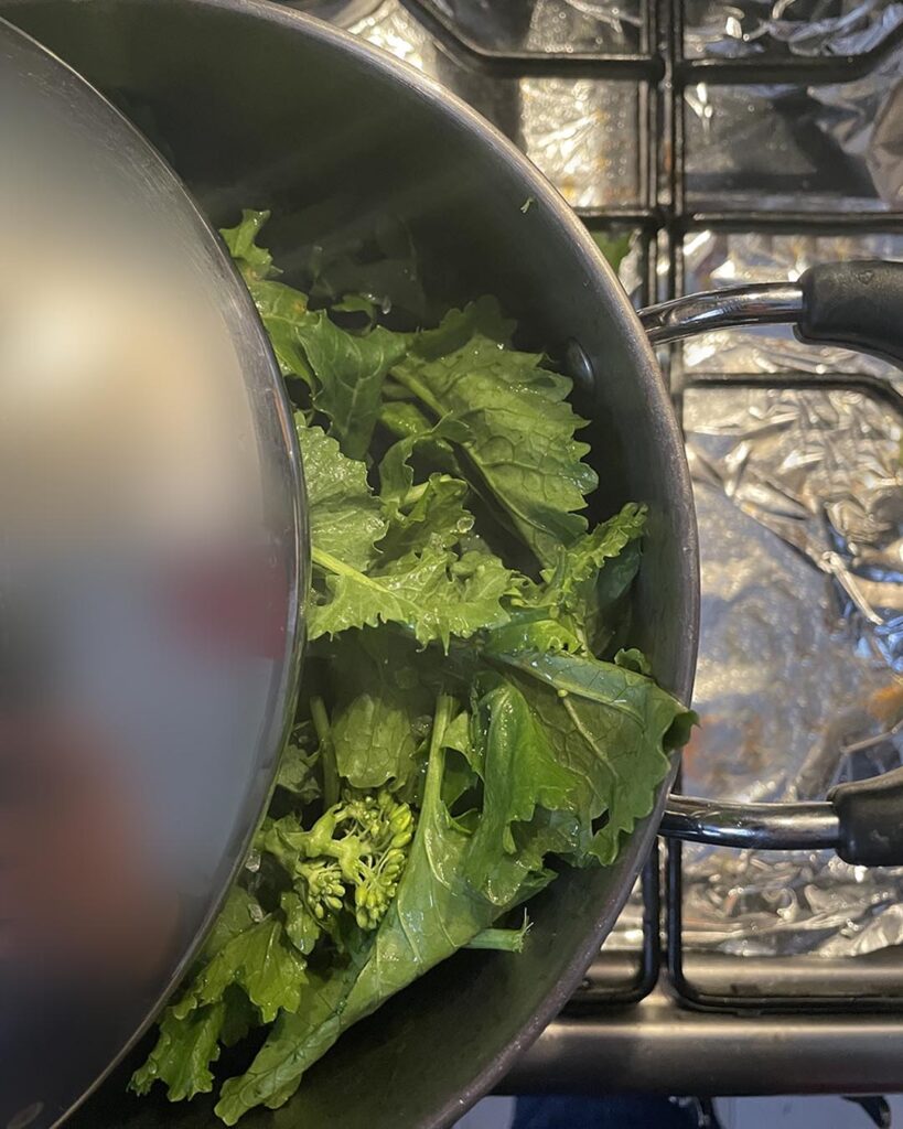 cooking turnip green covered with a lid
