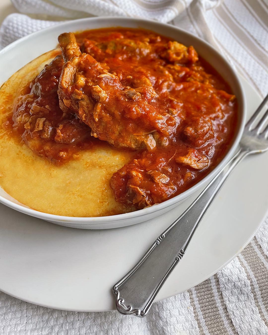 pork ribs with polenta served on a white dish