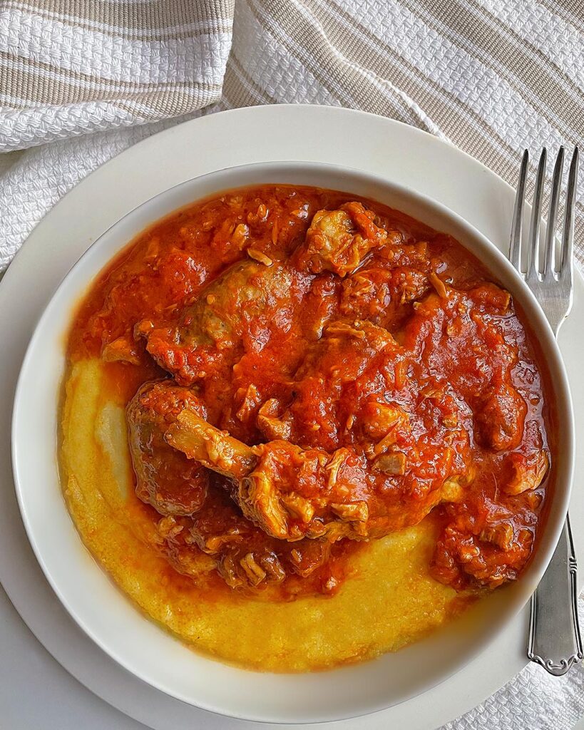 pork ribs with polenta served on a white dish