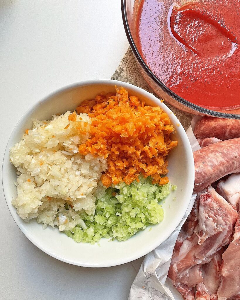 carrots, celery and onion minced and mixed to prepare the soffritto