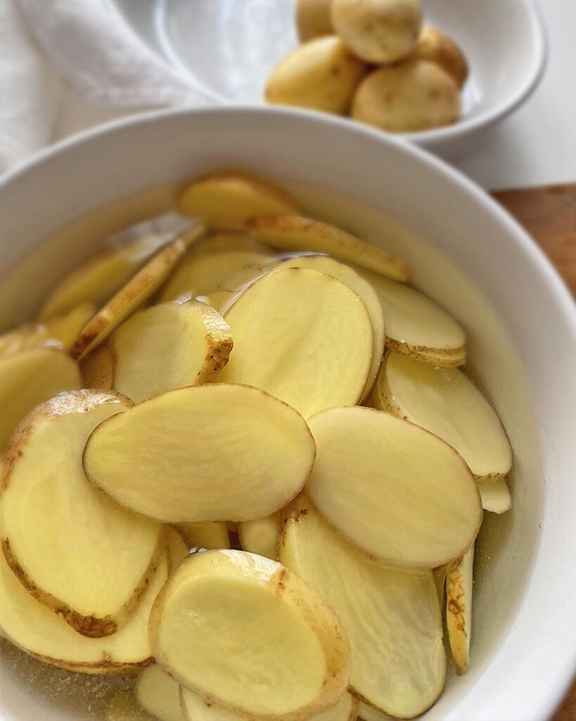 closeup of potatoes sliced in very thin slices