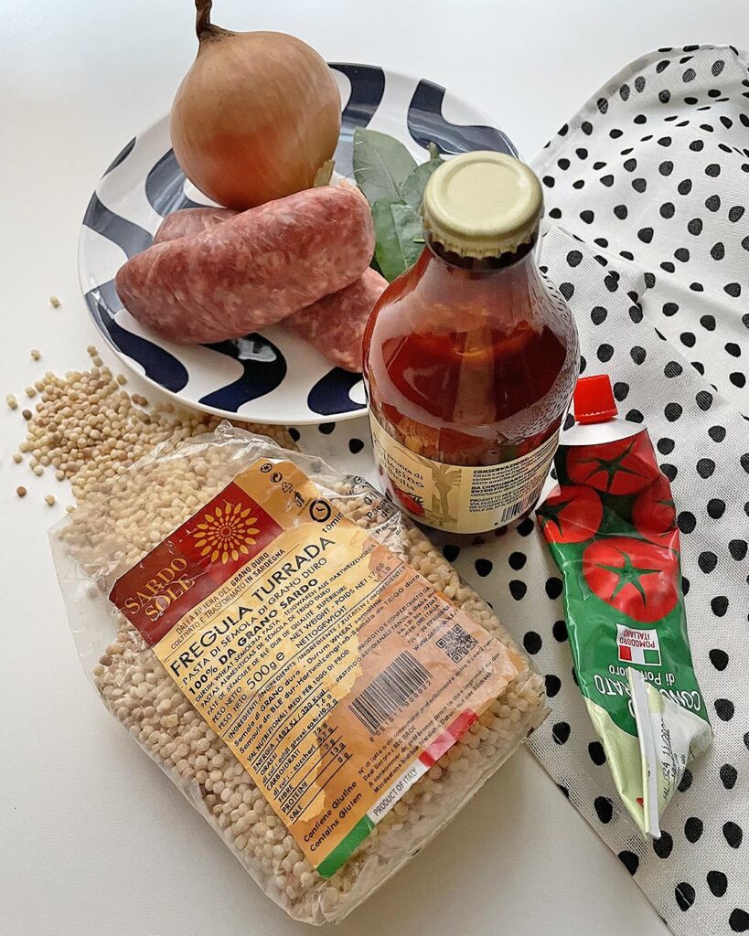 ingredient for fregula with sausage: fregula, sausages, tomato, tomato paste, bay leaves