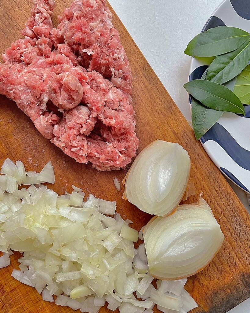 chopped onion and sausage on the chopping board