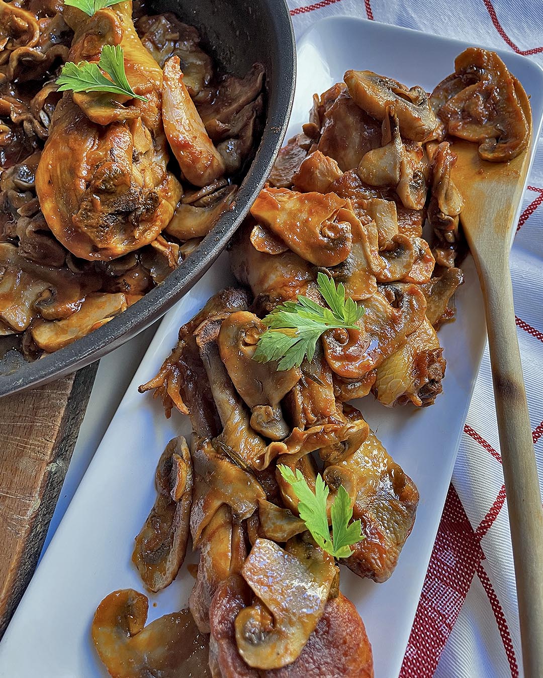 mushroom chicken thighs served on a white dish