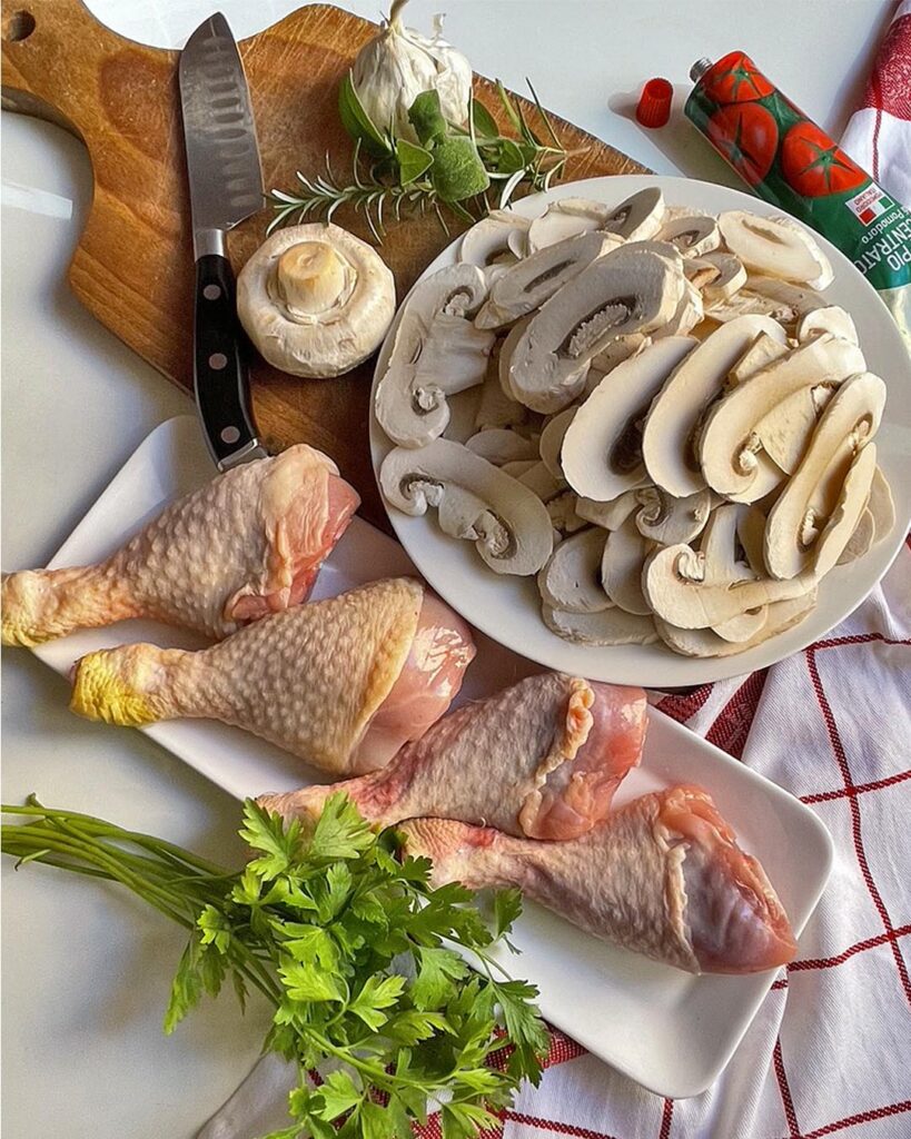 ingredients for mushroom chicken thighs: chicken, mushrooms, parsley, garlic, fresh herbs and tomato paste