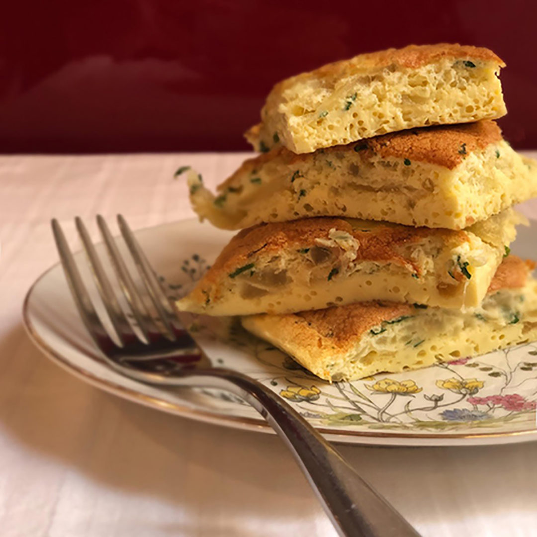 slices of onion omelette on a dish with a fork italian cooking tips