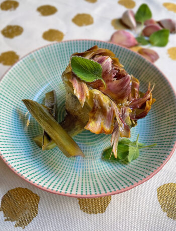artichoke roman style served on a green dish