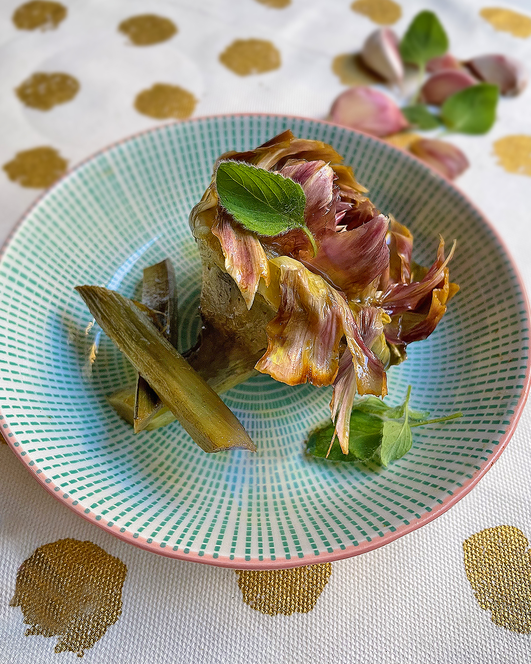 artichoke roman style served on a green dish